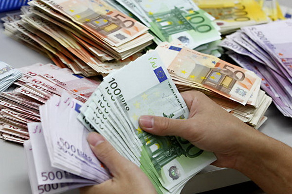 A bank employee counts Euro notes at Kasikornbank in Bangkok