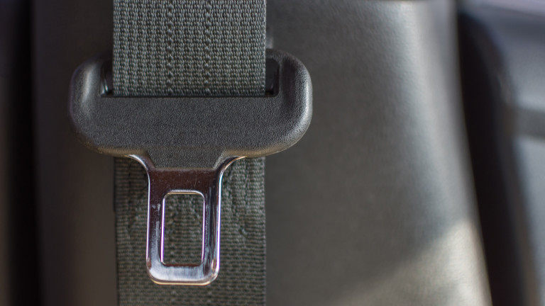 Car interior detail with car seat belt or safety belt in car